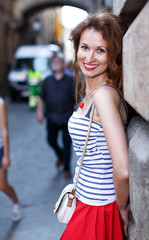 Portrait of woman walking outside on the city street.Female tourist walking outdoors.
