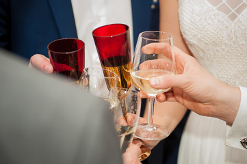 people clink glasses of champagne at the wedding
