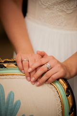 hands of the bride on the back of the chair on the wedding day