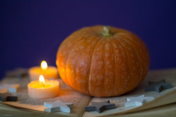 Happy Halloween with pumpkine, candle, books, stars and scrolls