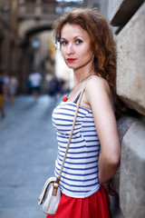 Portrait of woman walking outside on the city street.Female tourist walking outdoors.