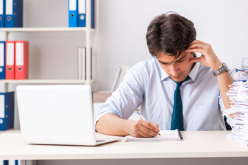 Young handsome businessman working in office
