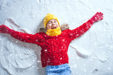 Kid making snow angel.