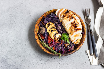 Roasted chicken breast and stewed red cabbage with mushrooms and tomatoes.