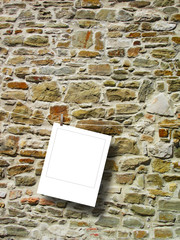 Blank square instant photo frame against brown old stone wall background