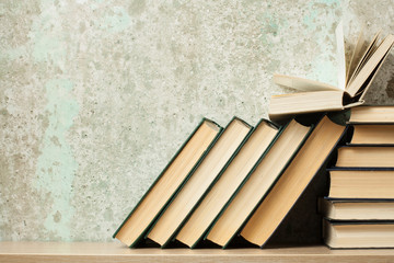 Open book, hardback books on wooden table. Education background. Back to school. Copy space for...