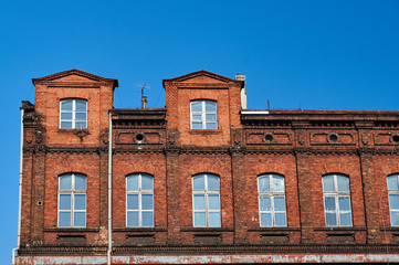 Obraz premium fragment of the facade of a red brick building in Poznan.
