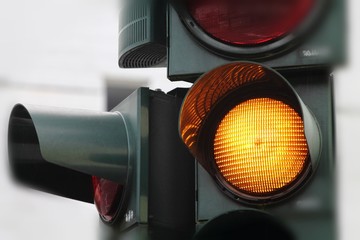 Yellow traffic light close up. German street. Mist wearther.