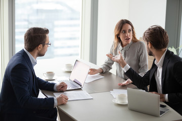 Angry man accusing shocked female colleague, intern, blaming for mistake. Disagreement,...