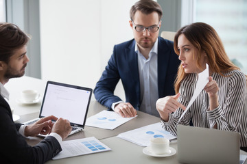 Businesswoman criticizes subordinate work, pointing out mistake in document. Business partners discuss terms of contract. Colleagues discuss business strategy.