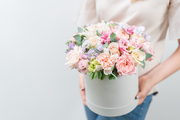 Beautiful spring bouquet in round box. Arrangement with various flowers. The concept of a flower...