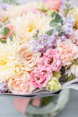 Beautiful spring bouquet in glass vase. Arrangement with various flowers. The concept of a flower shop. A set of photos for a site or catalogue. Work florist.