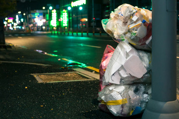 bags of garbage on the night street