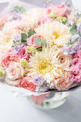 Beautiful spring bouquet in glass vase. Arrangement with various flowers. The concept of a flower shop. A set of photos for a site or catalogue. Work florist.