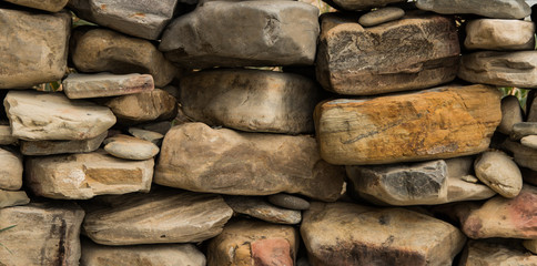 Background of stones. Abstract background of wild stones. Stone wall.  Handmade masonry stone
