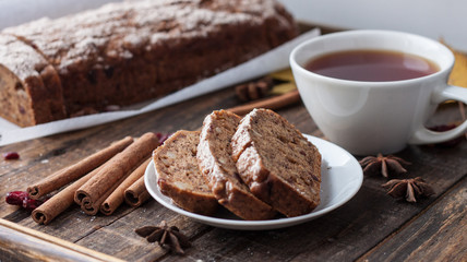 Homemade banana bread with anis star and cinnamon on a dark wooden background