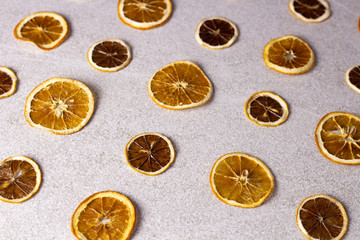 Dried sliced lemon and orange on white texture surface. Macro shot of fruits.
