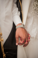 arab groom holds bride's hand