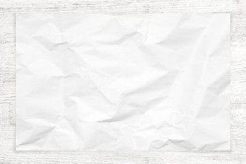 Crumpled paper texture on white wood background.