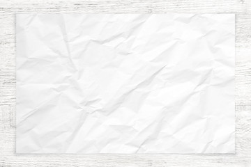 Crumpled paper texture on white wood background.