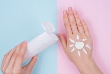 Flat lay flatlay top above high angle overhead close up view photo of lady applying cream on hand isolated on pastel pink blue background copy space