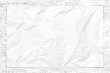 Crumpled paper texture on white wood background.