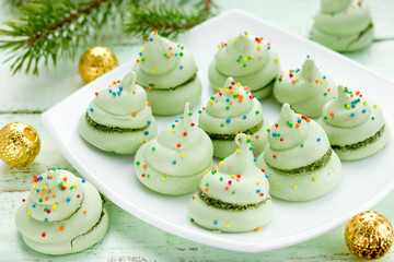 Christmas tree meringue - homemade green meringues with colorful sugar sprinkle balls shaped christmas tree, new year dessert idea