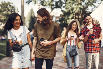 Two happy couples. Cheerful young loving couples having pleasant walk and smiling while relaxing outdoors