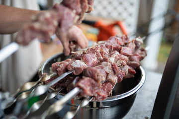 Pile of raw meat pieces on skewers (kebab barbecue).