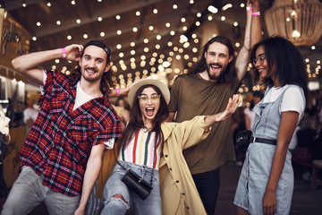 Party time. Cheerful emotional young people enjoying spending time together and making funny...
