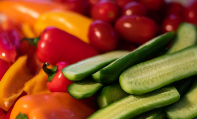Assorted vegetables - cucumbers, tomatoes, bell peppers.