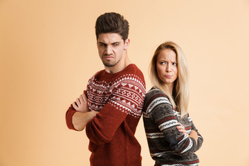 Portrait of an angry young couple dressed in sweaters