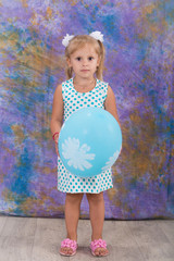 Happy child, little girl having fun playing with balloon. Freedom concept