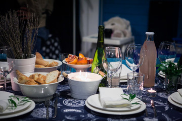 Festive table setting with lemonade, bread and sliced red orange