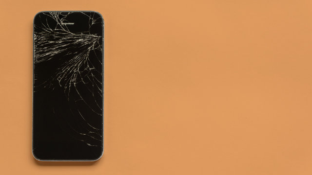 broken phone on a orange pastel background