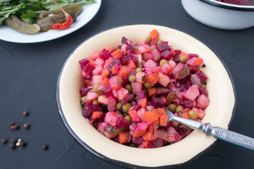 Appetizing and traditional salad Vinaigrette on a gray background