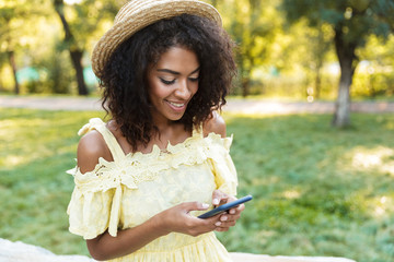 Cheerful young african woman in summer dress
