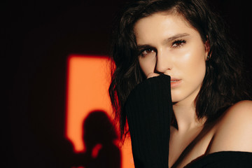 Seductive woman keeping hand near face