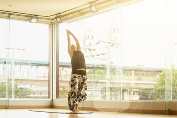 A yoga master practicing yoga performing Ardha Chandrasana or half moon pose