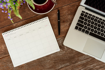 SEPTEMBER 17, 2018: Working table top with organizer for monthly planing with a pen, macbook air...