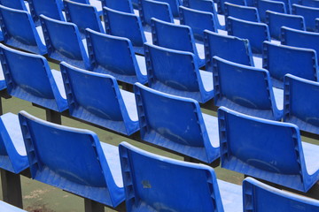 Lots of blue plastic chairs