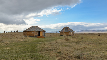 Fototapeta na wymiar traditional Khakas wooden houses in Kings Valley near Bolshoy Salbykskiy Kurgan Ust-Abakan district, Republic of Khakassia