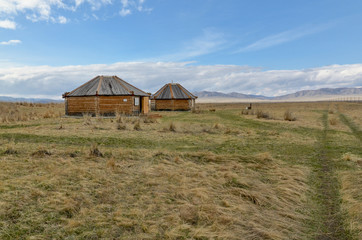 Fototapeta na wymiar traditional Khakas wooden houses in Kings Valley near Bolshoy Salbykskiy Kurgan Ust-Abakan district, Republic of Khakassia