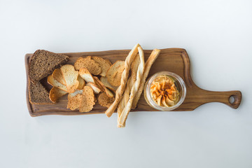 Traditional Middle east appetizer Hummus served with chips of bread and herbs.
