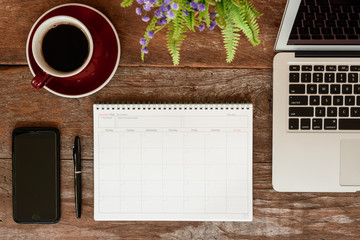 SEPTEMBER 17, 2018: Working table top with organizer for monthly planing with a pen, Macbook air,...