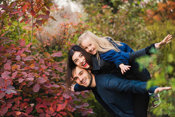 Happy young family smile in autumn park