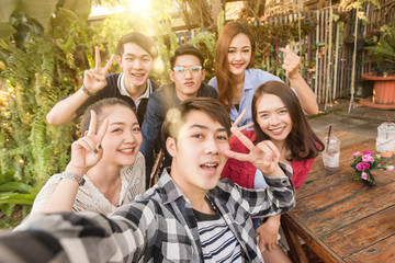 Group of six teenagers taking selfie with fun together in afternoon