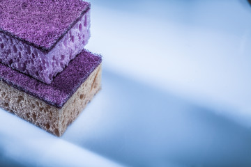 Dishwashing sponges on white surface