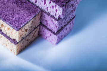 Pile of kitchen sponges on white surface