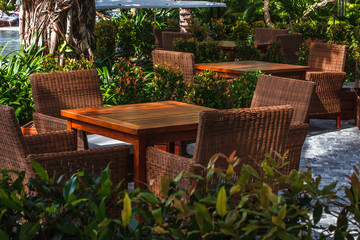 Fototapeta premium Sunny outdoor terrace with rattan furnitures